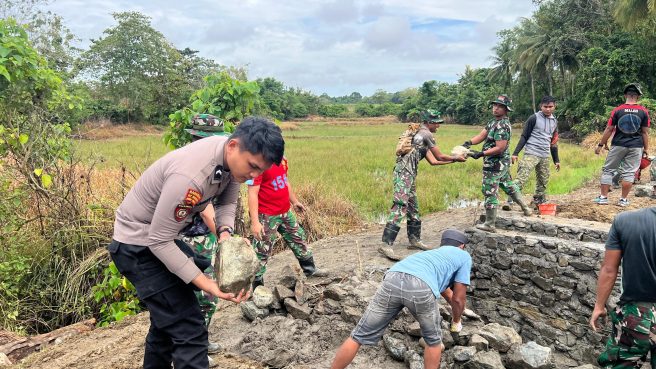 Anggota TNI dan Polri bersama warga bergotong royong membangun jembatan di pedesaan dalam program TMMD ke-124 Kodim 1406/Wajo.