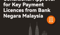 Logo XTransfer dan pengumuman persetujuan lisensi pembayaran dari Bank Negara Malaysia (BNM).